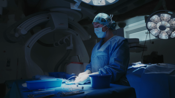 Surgeon preparing instruments in operating room